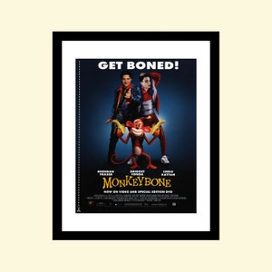 May include: Movie poster for the film "Monkeybone" featuring Brendan Fraser, Bridget Fonda, and Chris Kattan. The poster has a dark blue background with the title "Monkeybone" in white letters. The tagline "Get Boned!" is in white letters at the top of the poster. The actors are shown standing in front of a cartoon monkey holding two bananas.