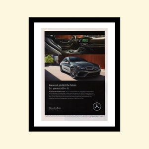 May include: A black Mercedes-Benz E-Class sedan driving on a city street. The ad copy reads "You can't predict the future. But you can drive it."  The Mercedes-Benz logo is in the bottom right corner.