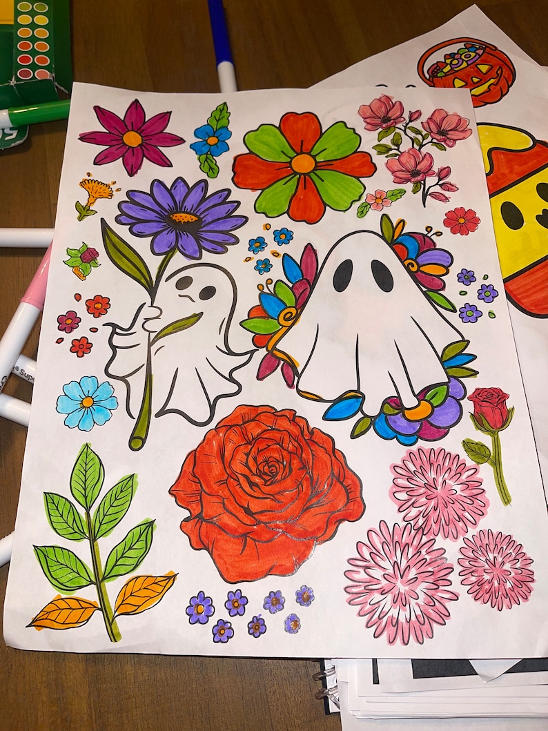 May include: A coloring page with a variety of colorful flowers, leaves, and two ghosts. The ghosts are white with black eyes and mouths. The flowers are in shades of pink, purple, red, orange, and yellow. The leaves are green and brown.