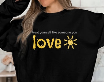May include: Black sweatshirt with the text "treat yourself like someone you love" in yellow with a sun graphic.