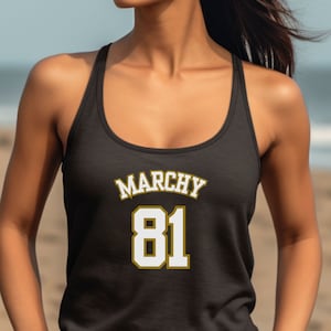 May include: Black tank top with a gold and white graphic that says "Marchy 81".
