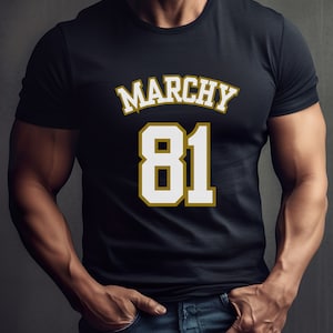 May include: A black t-shirt with a white number 81 and the word "MARCHY" in gold lettering.