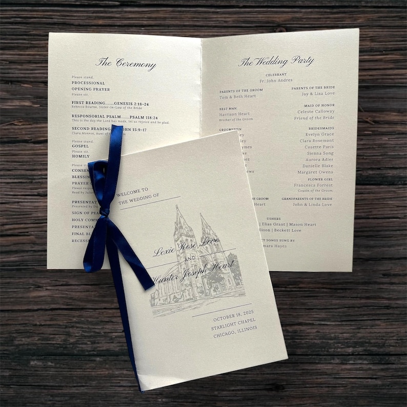 May include: Wedding program tied with a navy blue ribbon. The program is light-coloured with black text and a church illustration. The text reads "Welcome to the Wedding of Lexie Rose Love and Hunter Joseph Heart".