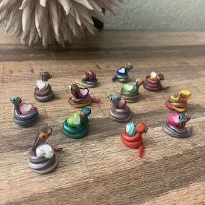 Random Tiny Clay Multicolored Snake Figurines Holding Plastic Hearts