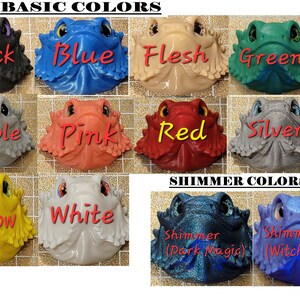 May include: A collection of 12 miniature bearded dragon figurines in various colors, including black, blue, flesh, green, marble, pink, red, silver, yellow, white, shimmer (dark magic), and shimmer (witchcraft).