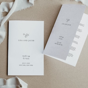 May include: A white wedding invitation with a simple floral design and the text "Lisa and Jacob" and "Ani L'dodi V'dodi Li" in Hebrew. The date is July 3, 2023 and the location is New York, New York.