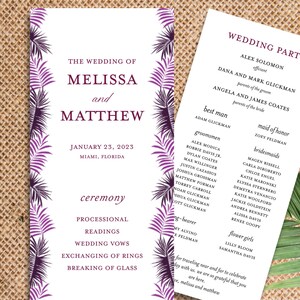 May include: Wedding ceremony program with purple and white tropical leaf design. The program lists the wedding date, location, and ceremony details, including processional, readings, wedding vows, exchanging of rings, and breaking of glass.