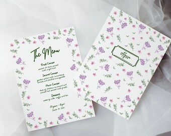 May include: A white wedding menu card with a floral border and the text "The Menu" in black cursive. The menu lists the courses for the wedding reception, including the names of the bride and groom and the date of the wedding.