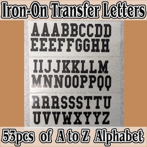 May include: A set of 53 black iron-on transfer letters for crafting projects. The letters are arranged in alphabetical order on a white background. The letters are uppercase and are in a bold, blocky font.