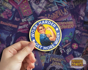 May include: A blue and yellow round sticker with a white star and the text "Work Harder Get More Work". A woman with red hair and a red bandana is depicted with her arm raised in a "We Can Do It" pose.