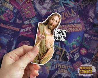 May include: A sticker featuring a painting of Jesus with the text "I saw that." The sticker is placed on a background of various comic book covers.