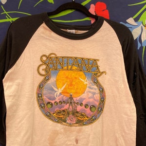 Vintage 70s 80s Santana band T-shirt with double sided psychedelic graphic distressed raglan band T-shirt