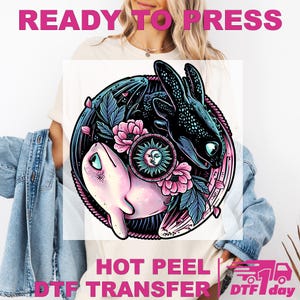May include: A white t-shirt with a colorful graphic featuring two stylized creatures, surrounded by flowers and leaves. The design includes a sun with a face in the center. The words "READY TO PRESS" and "HOT PEEL DTF TRANSFER" are printed on the image.