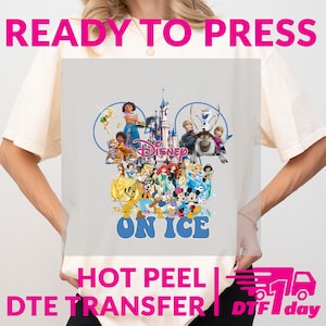 May include: A light-colored t-shirt featuring a colorful Disney graphic. The graphic includes various Disney characters, the Disney logo, and the text "ON ICE". The shirt also has the text "READY TO PRESS", "HOT PEEL", and "DTE TRANSFER".