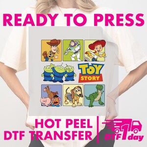 May include: A white DTF transfer featuring characters from the Toy Story movie. The transfer includes images of Woody, Buzz Lightyear, Jessie, the Aliens, and other characters. Text at the top reads "READY TO PRESS" and at the bottom "HOT PEEL DTF TRANSFER".