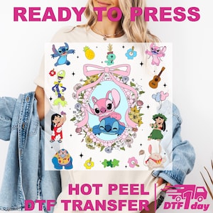 May include: A DTF transfer with the text "READY TO PRESS" and "HOT PEEL DTF TRANSFER". The design includes cartoon characters, flowers, and a ukulele. The central image features two characters in a floral frame. The transfer is suitable for hot peel application.