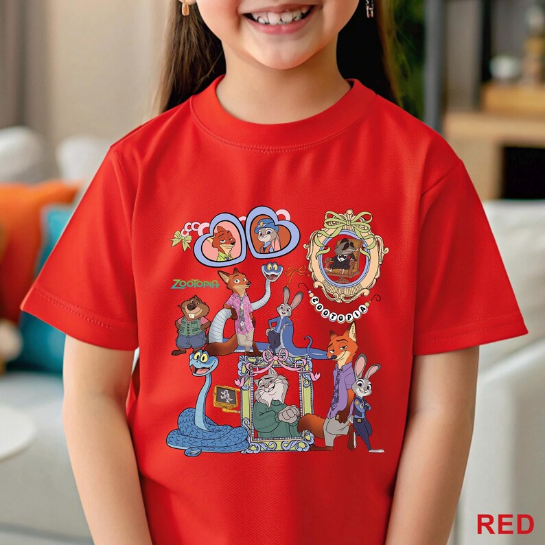May include: A red t-shirt with a vibrant graphic of characters from the film "Zootropolis." The design showcases animal characters in frames and scenes, with the word "Zootopia" in green. The shirt is made of a soft material.