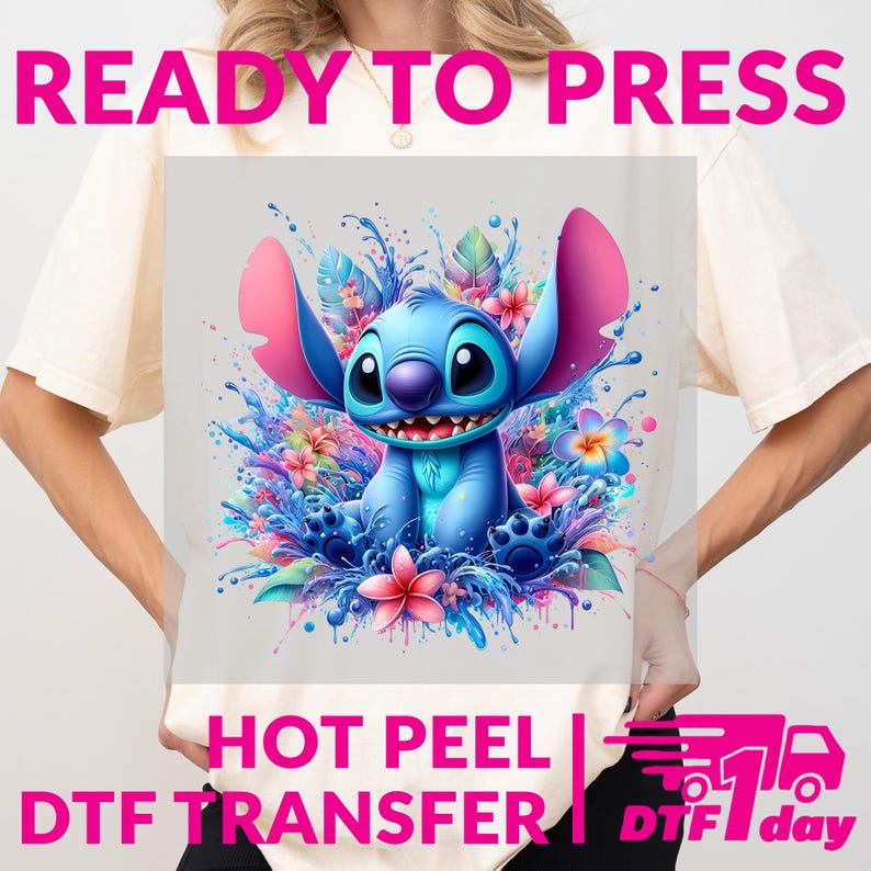 May include: A light-colored t-shirt featuring a vibrant graphic of a blue cartoon character with large ears, surrounded by colorful flowers and water splashes. The text "READY TO PRESS" and "HOT PEEL DTF TRANSFER" are displayed in pink and white.