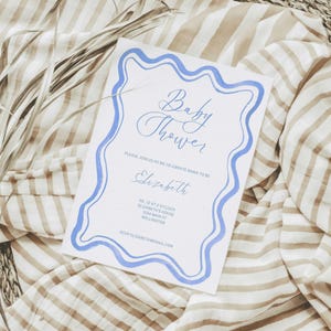 Baby shower invite template with scalloped retro wavy blue watercolor border perfect for a baby boy fully editable canva template