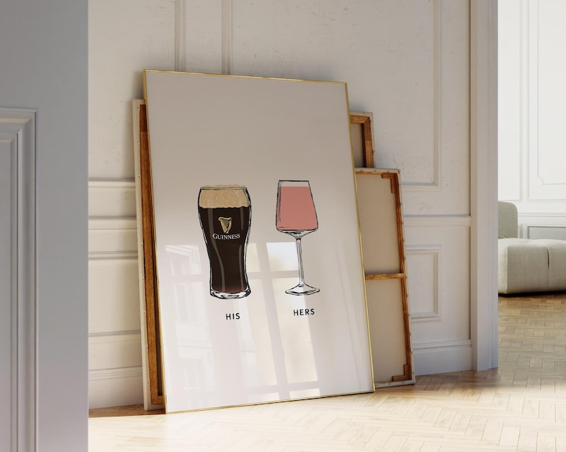 May include: A framed print featuring two illustrated glasses: a pint of Guinness and a wine glass. The Guinness glass is dark with a white head, and the wine glass is filled with pink liquid. The words "HIS" and "HERS" are below the glasses.