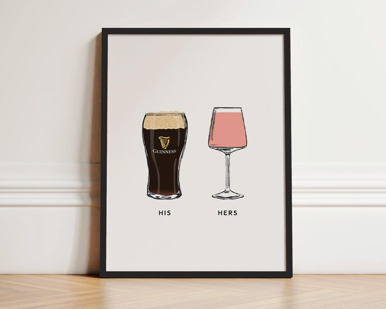 May include: Framed art print featuring two illustrated glasses: a pint of Guinness and a stemmed glass with a pink drink. The words "HIS" and "HERS" are printed below the glasses. The print is in a black frame.