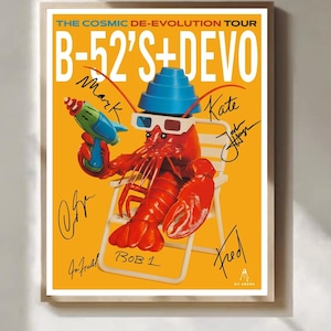 May include: A concert poster for The Cosmic De-Evolution Tour featuring B-52's and Devo. The yellow poster shows a red lobster wearing a blue energy dome hat and 3D glasses, holding a toy ray gun while sitting in a white chair, with multiple signatures.