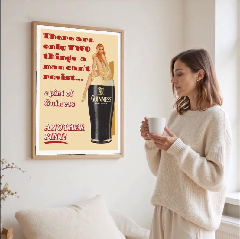 May include: Framed vintage-style Guinness advertisement. The poster features a pint of Guinness stout with a pin-up girl illustration. Text reads "There are only TWO things a man can't resist... a pint of Guinness. ANOTHER PINT!"