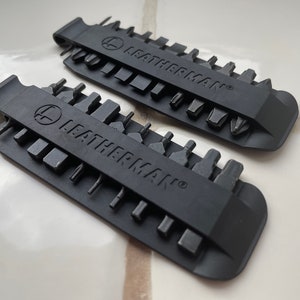 May include: Two black Leatherman bit kits with a variety of different sized bits. The kits are made of a durable plastic and have a clip for easy carrying.