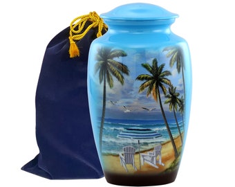 May include: A blue ceramic urn with a beach scene featuring palm trees, an umbrella, and two chairs. The urn comes with a blue velvet bag with a gold drawstring.