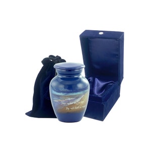 May include: Blue cremation urn featuring a beach scene and the quote "There are places we love to go, but may never go again. They will reside in memory." The urn is supplied with a blue velvet bag and box.