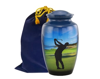 May include: Blue and black urn with a golfer silhouette on a green golf course. The urn comes with a blue velvet bag with a gold drawstring.