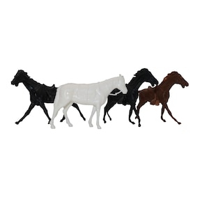 May include: Four plastic toy horses in different colors: black, white, brown, and black with a brown saddle. The horses are standing in a row, facing the right.