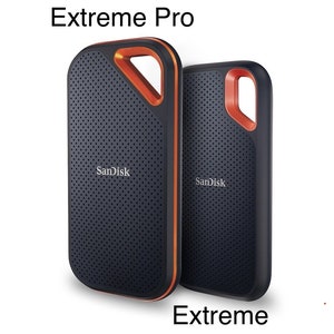 May include: Two SanDisk portable solid state drives with a black perforated surface and orange trim. The larger drive is labelled Extreme Pro and the smaller drive is labelled Extreme. Both feature a cutout corner for attachment.