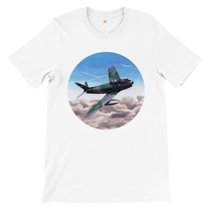 May include: White t-shirt with a circular graphic of a green and gray fighter jet flying through clouds. The jet has a German flag on the tail and the text "BR-173" on the side.