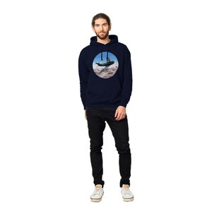 May include: A navy blue hooded sweatshirt with a circular graphic of a green airplane flying through clouds.