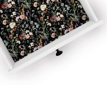 May include: A white drawer with a black floral patterned liner. The drawer has a black knob.