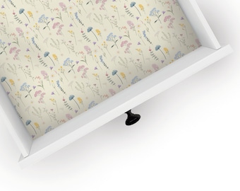 May include: A white drawer with a floral pattern liner. The drawer is open and the liner is visible. The drawer has a black knob.