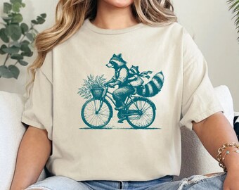 Funny Raccoon Bicycle T-Shirt: Quirky Animal Lover Tee