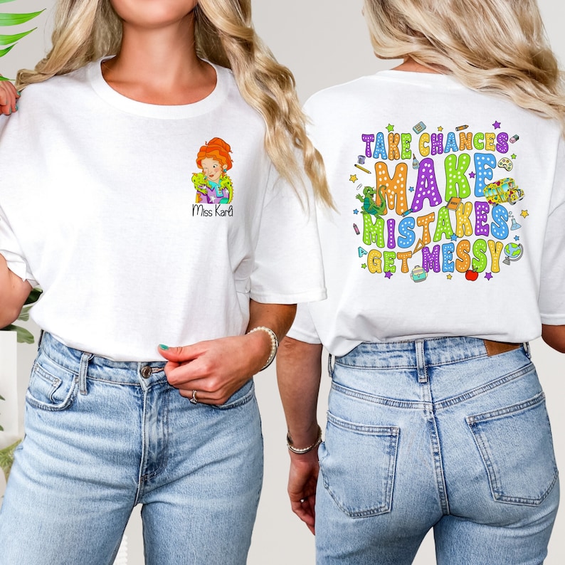 May include: White t-shirt with a cartoon teacher illustration and the text "Miss Kari" on the front. The back of the shirt has the text "Take Chances Make Mistakes Get Messy" with colorful school supplies and stars.