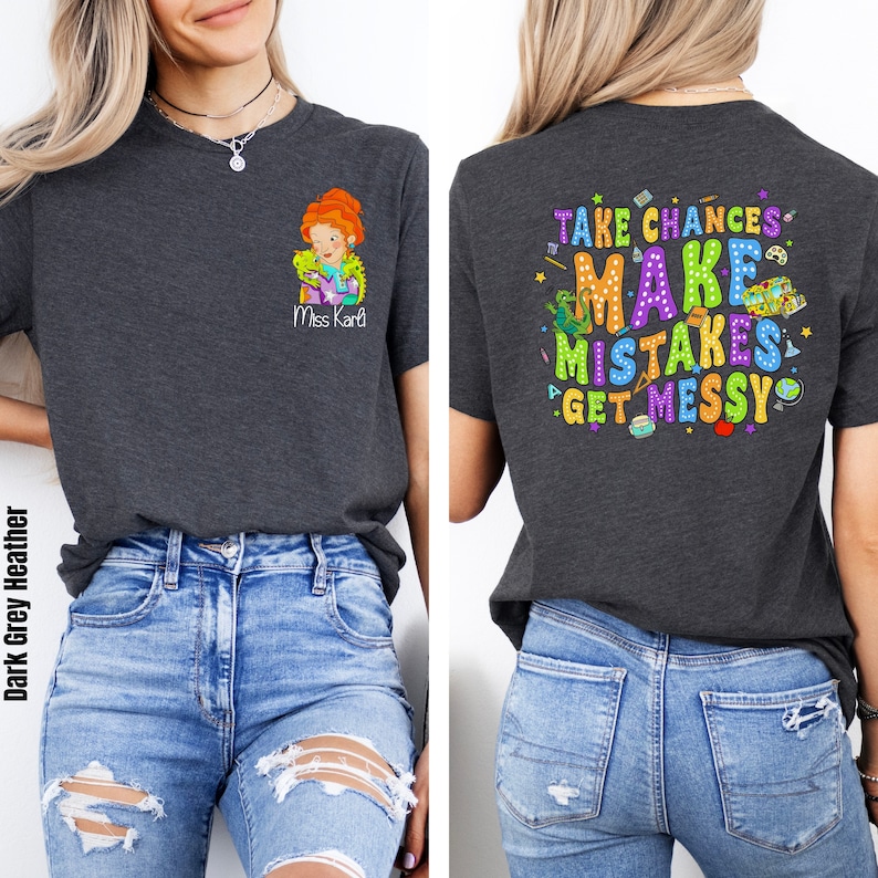 May include: Dark grey heather t-shirt with a colorful graphic on the back that says "Take Chances Make Mistakes Get Messy". The front of the shirt has a small graphic of a woman with the text "Miss Kari".