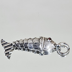 Beautiful articulated fish pendant in sterling silver and small red stones
