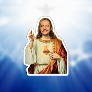 May include: A digital art print of a man with a beard and long hair, wearing a white robe and a red sash, with a heart on his chest. The background is a blue sky with clouds.