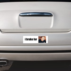 May include: A white bumper sticker with the text "i brake for" and a photo of a man.