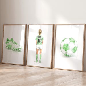 May include: Three framed watercolor illustrations. The first shows a green and white soccer cleat. The second shows a female soccer player wearing a green and white jersey with the number 10 and the name Sammy. The third shows a green and white soccer ball.