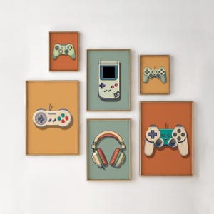 May include: Set of six framed prints featuring retro gaming controllers, a handheld game console, and headphones. The prints are in various colours, including orange, green, blue, and yellow.