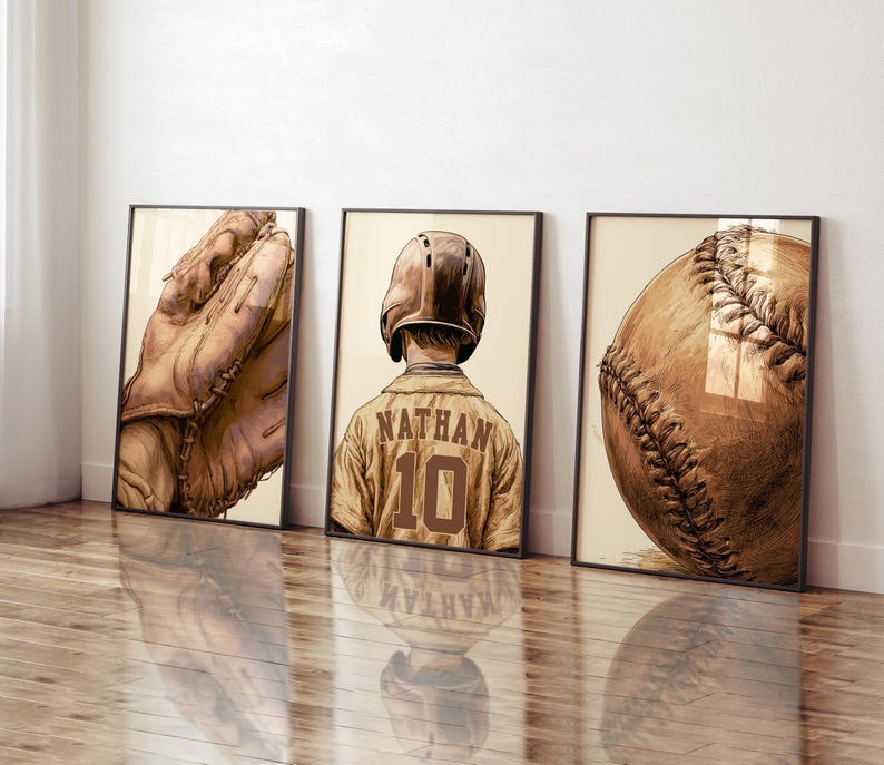 May include: Three framed wall art prints featuring baseball themes in a sepia-toned illustration style. The left print shows a leather baseball glove, the center print depicts a player wearing a helmet and jersey with the name NATHAN and number 10, and the right print displays a close-up of a baseball.