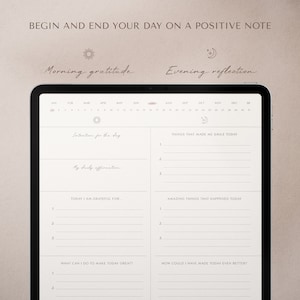May include: A digital tablet screen displaying a daily planner with sections for morning gratitude and evening reflection. The planner includes prompts for setting intentions, daily affirmations, things that made you smile, and amazing things that happened. The tablet is on a light brown surface.
