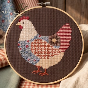 May include: A circular wooden embroidery hoop containing a cross-stitch design of a chicken against a dark brown background. The chicken features a white head, red comb and wattle, and a body patterned with blue, red, and orange geometric shapes.