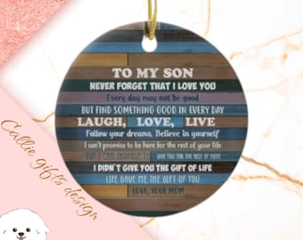 May include: A round wooden ornament with a blue and brown woodgrain pattern. The ornament has a gold string for hanging and features a message for a son: "To my son, never forget that I love you. Every day may not be good, but find something good in every day. Laugh, love, live. Follow your dreams, believe in yourself. I can't promise to be here for the rest of your life, but I can promise to love you for the rest of mine. I didn't give you the gift of life, life gave me the gift of you. Love, your mom."