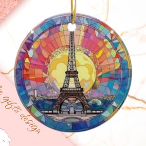 May include: A round, colorful, stained glass ornament featuring the Eiffel Tower in Paris, France. The ornament has a red, orange, yellow, green, blue, and purple color scheme.